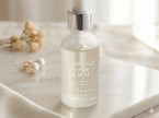 Custom clear BOPP roll labels on a frosted glass skincare serum bottle, featuring crisp solid white ink and a seamless no-label look.