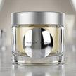 Custom kiss-cut mirror chrome stickers applied to a premium cosmetic jar, showcasing high-shine reflective metallic surfaces.