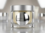 Custom kiss-cut mirror chrome stickers applied to a premium cosmetic jar, showcasing high-shine reflective metallic surfaces.
