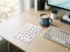 Custom kiss-cut white vinyl stickers featuring a square backing for easy peeling and durable waterproof material.