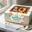 Custom semi-gloss roll labels on a modern bakery pastry box, featuring vibrant colors and professional coated paper finish.