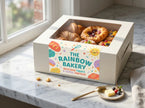 Custom semi-gloss roll labels on a modern bakery pastry box, featuring vibrant colors and professional coated paper finish.