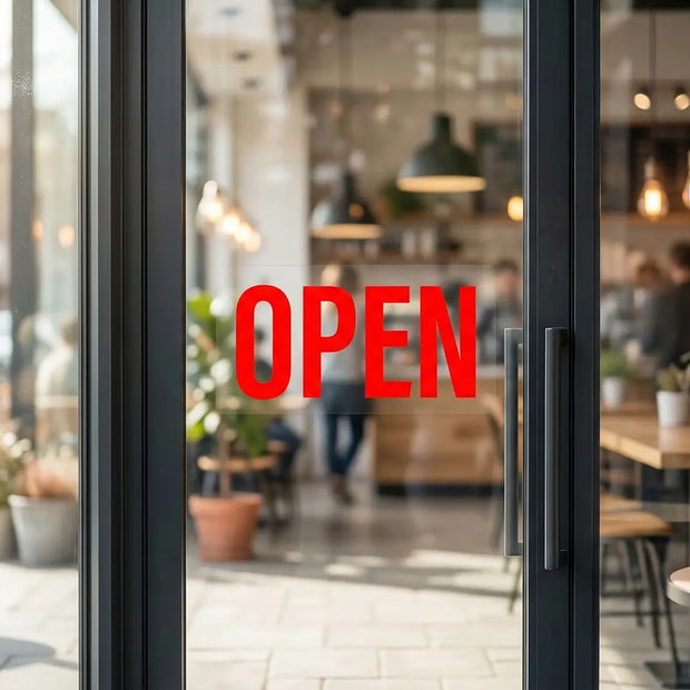 Double sided UV decal applied to a glass cafe door, showing a vibrant red OPEN sign that is 100% opaque with a 5-layer blockout printing technology.