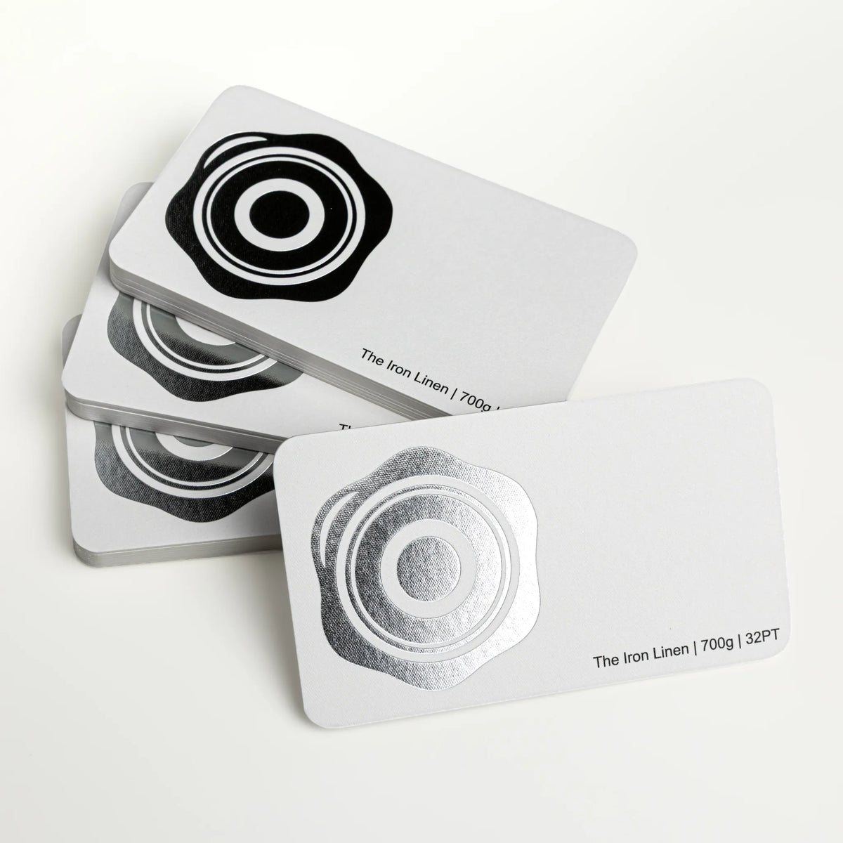 Professional executive desk setting featuring the OTTORON BC07 bespoke The Iron Linen business card.