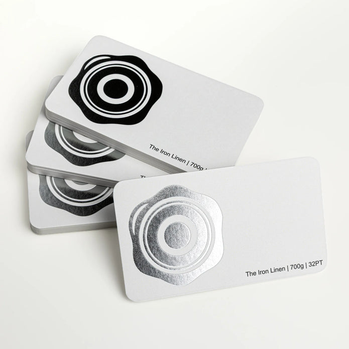 Professional executive desk setting featuring the OTTORON BC07 bespoke The Iron Linen business card.