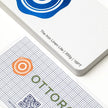 Professional executive desk setting featuring the OTTORON BC25 bespoke The Iron Linen Lite business card.