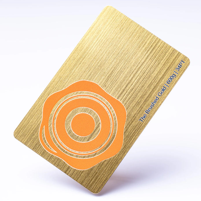 Professional executive desk setting featuring the OTTORON BC33 bespoke The Brushed Gold business card.