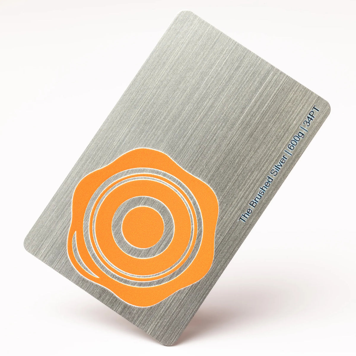 Professional executive desk setting featuring the OTTORON BC34 bespoke The Brushed Silver business card.